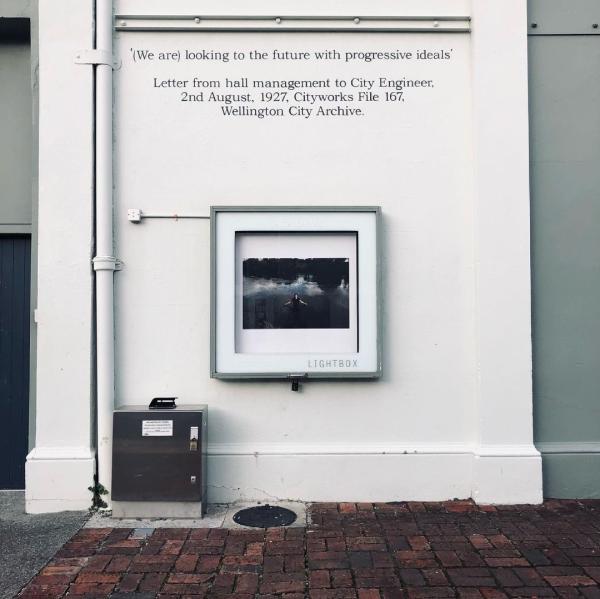 Image of lightbox at Thistle hall with colour image of Wahine standing in the water of the river in Te Teko  