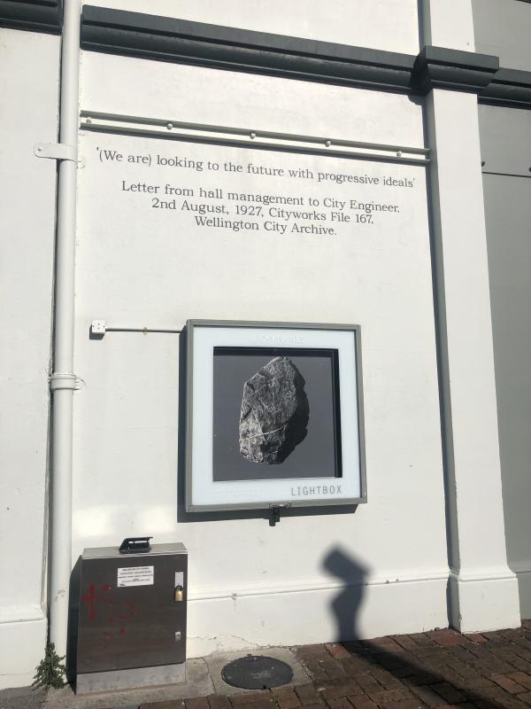 Image of lightbox at Thistle hall in sunlight with Colour image of a grey rock floating on a dark grey background