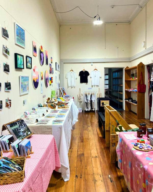 A room full of market goods on tables and on the wall