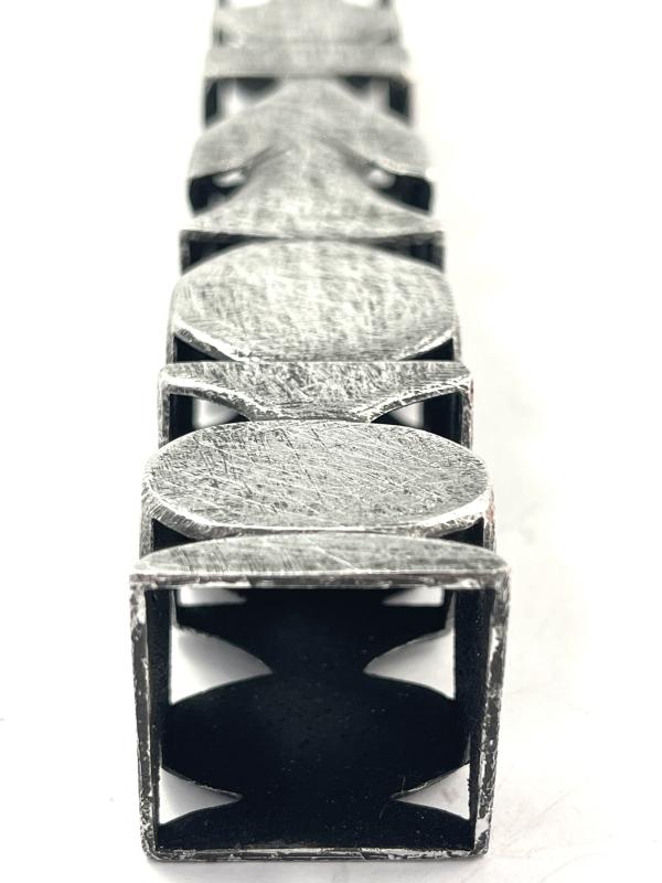 A close up of an experimental-looking piece of intriguing silver jewellry by Phillipa Gee