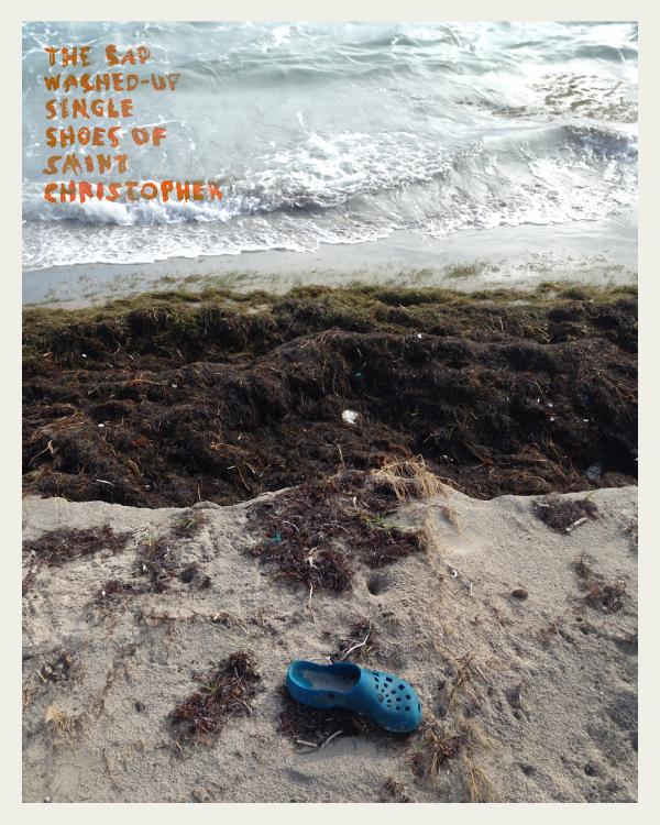 Photograph by Catherine Bisley. A lone blue shoe (rubber clog style) washed up on a sandy beach.