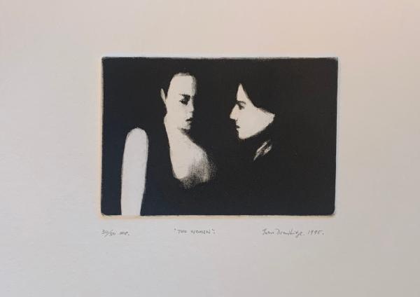 Two Women, 1995, a print by John Drawbridge. A soft a moody image, two women emerge from darkness. One is in the foreground, her face in profile. The second is slightly further back. Her face is half shrouded in shadow and her pale neck and bare upper arm glow white.