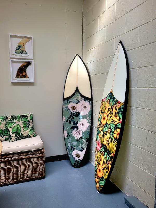 Nick Marshall surf boards displayed standing upright in a room corner.