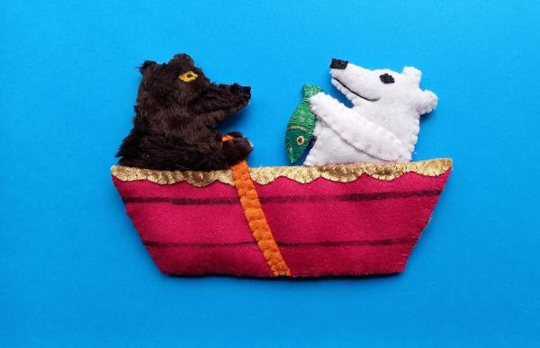 3D felted picture by Michelle Irving. A black bear and a polar bear on a little boat have caught a fish.