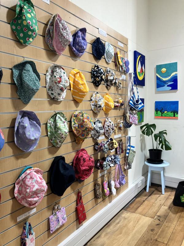 Hand made hats and colourful canvases for sale