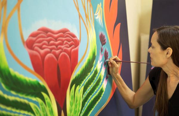 Emily Fletcher painting her work The Tree of Awakening