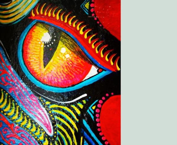 Detail of 'Devi" a mask by James Harcourt. A phoenix palm leaf painted with an animalistic face.